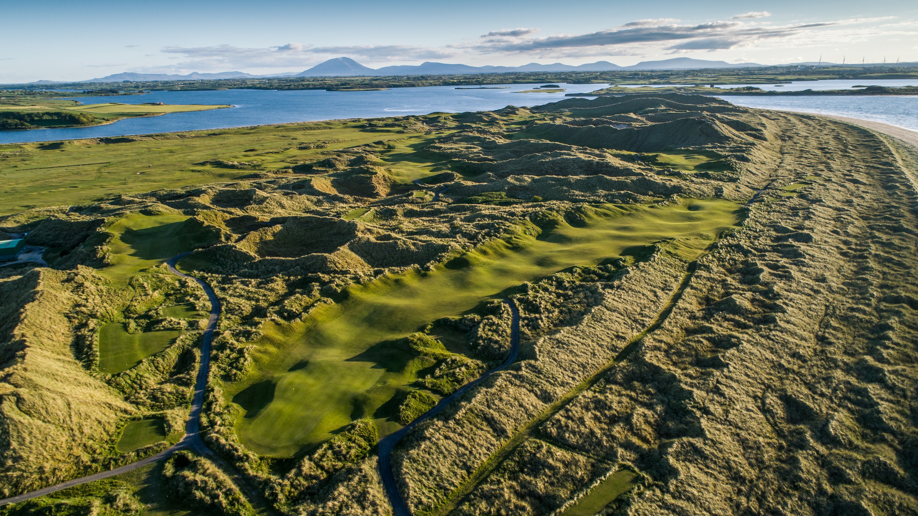 Aerial view of Enniscrone Golf Club with Killala Bay and the mountains of Mayo beyond