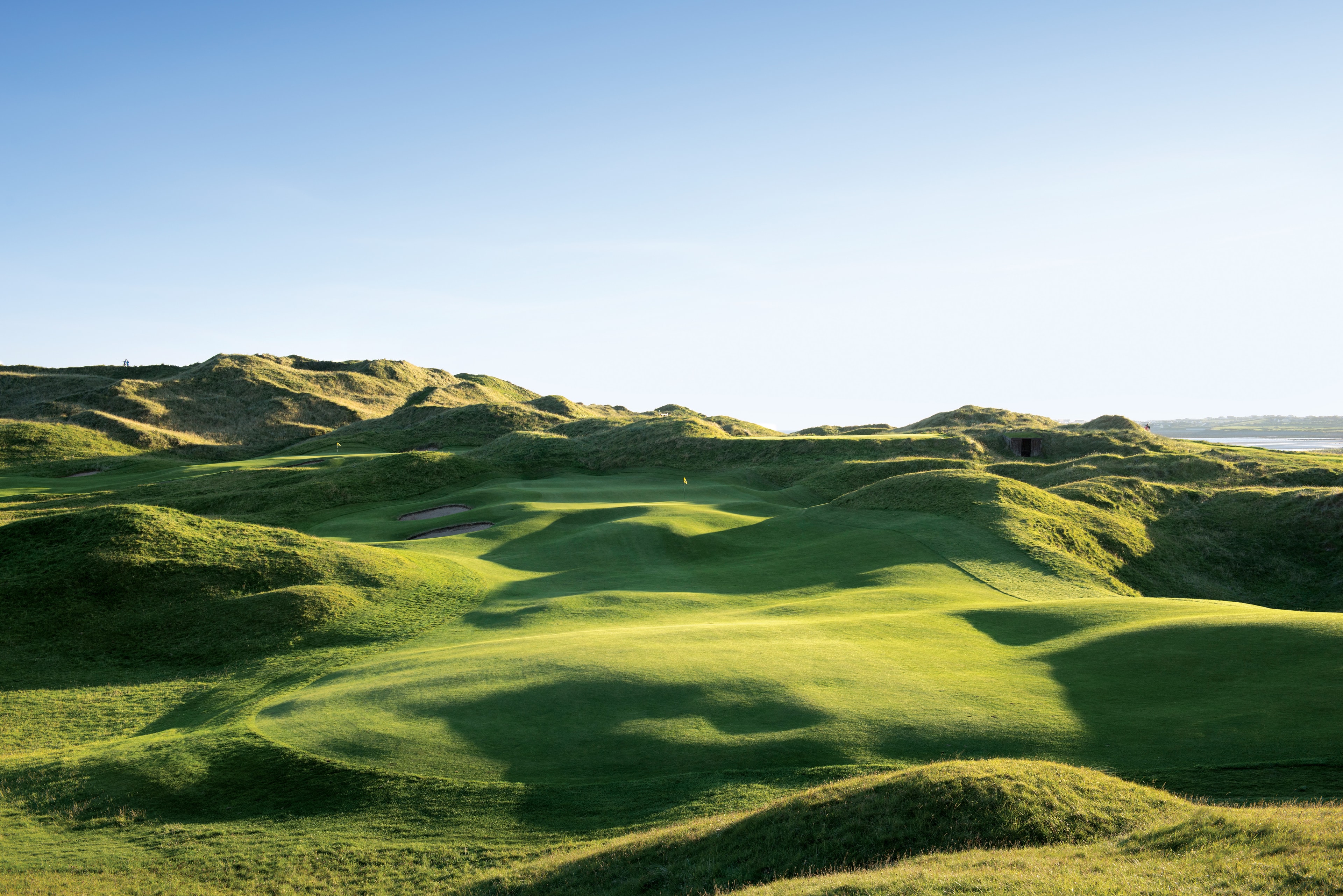 13th hole at Lahinch Golf Club with Lahinch beach and the bay stretching beyond