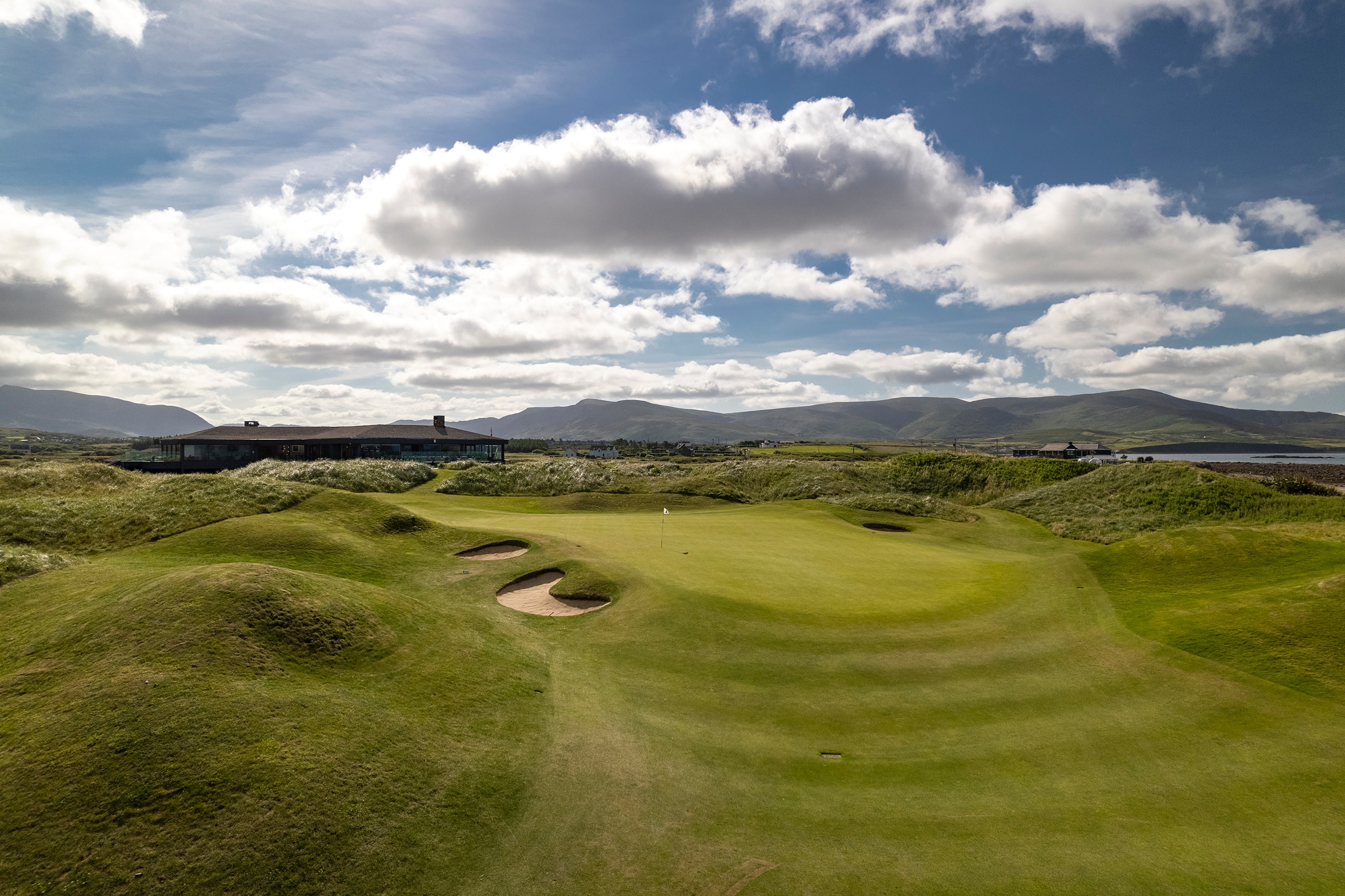 Approach to the 18th green at Waterville with the modern clubhouse visible