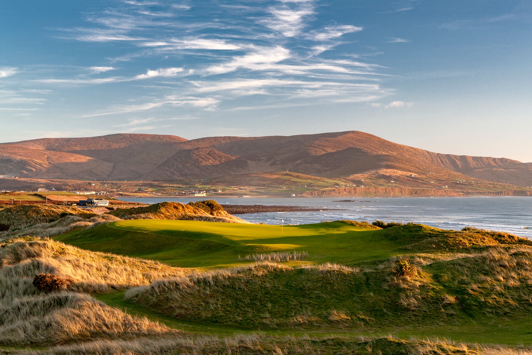 Golden hour light on Waterville Golf Links with the MacGillycuddy's Reeks beyond