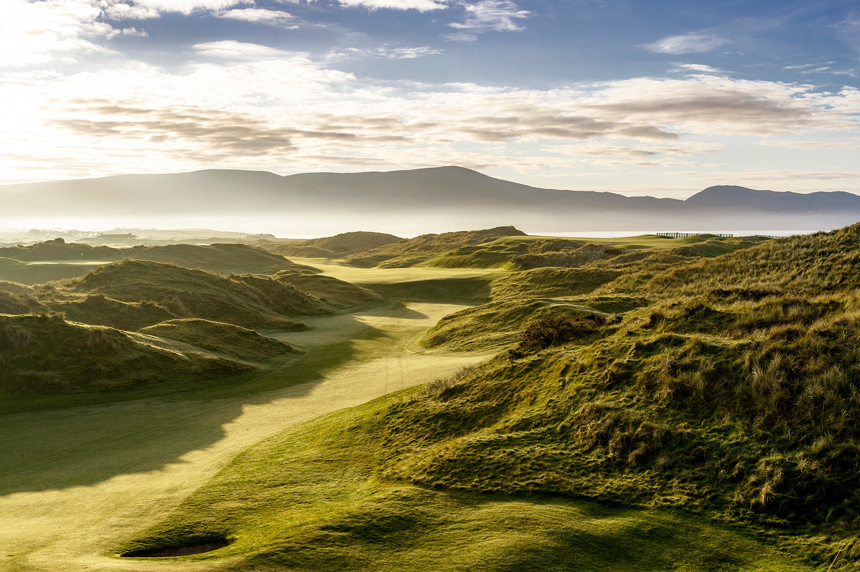 Hole 11 at Waterville with golden morning light raking through the dunes